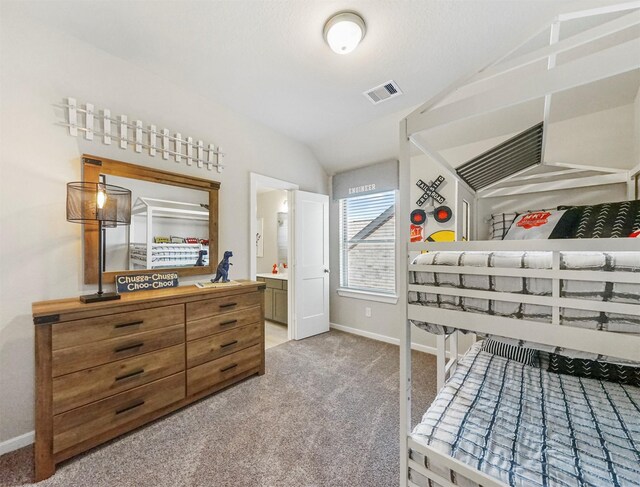 bedroom featuring baseboards, visible vents, carpet flooring, and lofted ceiling