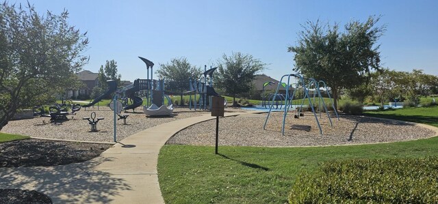 community jungle gym featuring a yard