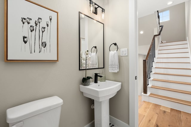 bathroom with toilet and wood finished floors