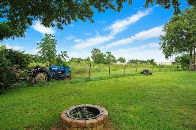 view of yard with a rural view and a fire pit