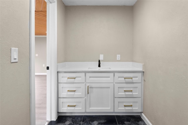 bathroom featuring vanity and baseboards