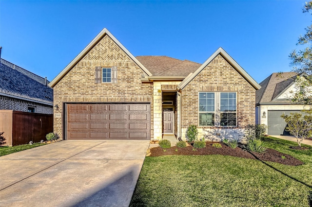 view of front of house with brick siding, a front lawn, fence, roof with shingles, and driveway