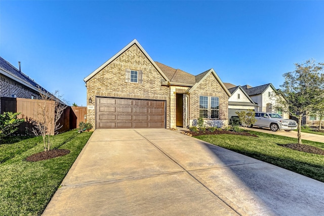 view of front of house with brick siding, concrete driveway, and a front yard