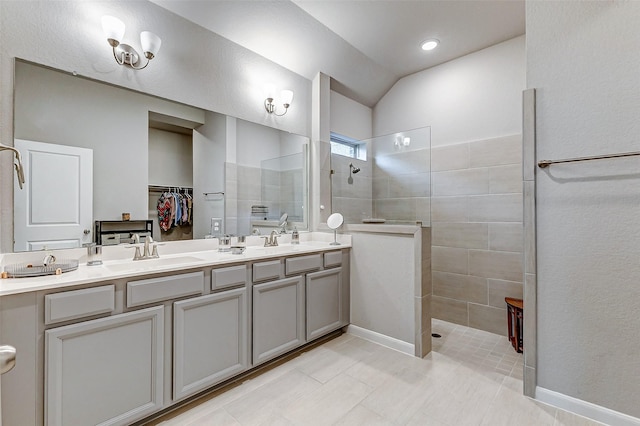 full bathroom featuring a sink, vaulted ceiling, double vanity, and a walk in shower