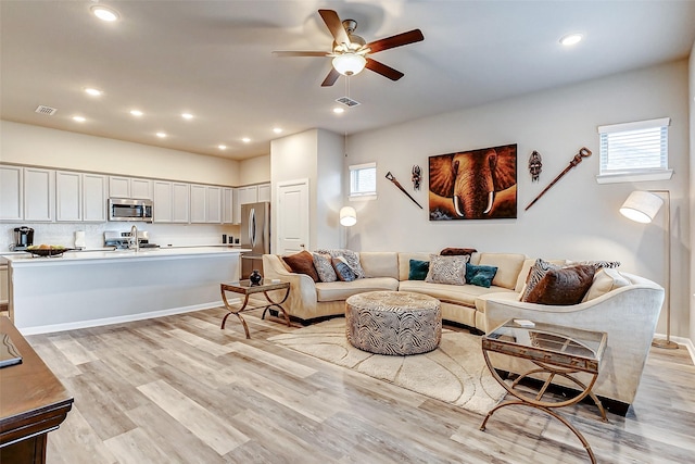 living area with recessed lighting, light wood-style floors, visible vents, and ceiling fan