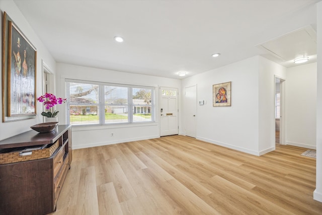 foyer entrance with recessed lighting, baseboards, and light wood-type flooring