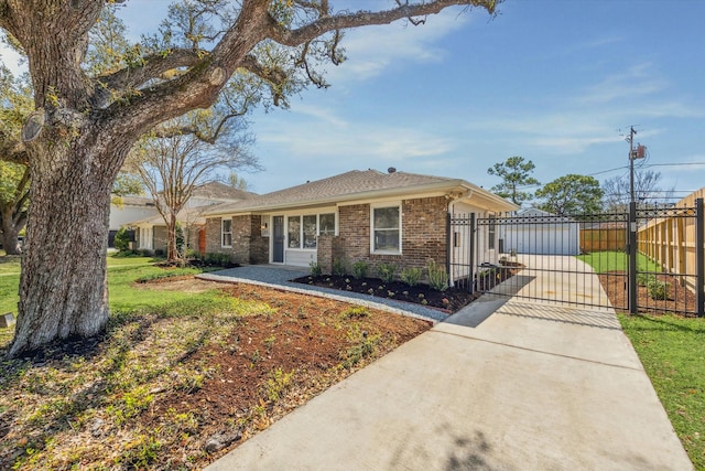 view of front of home with a gate, fence, and brick siding