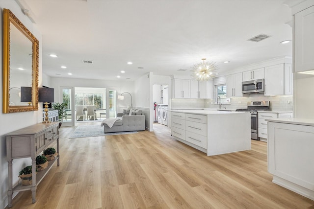 kitchen featuring light countertops, white cabinets, visible vents, and appliances with stainless steel finishes