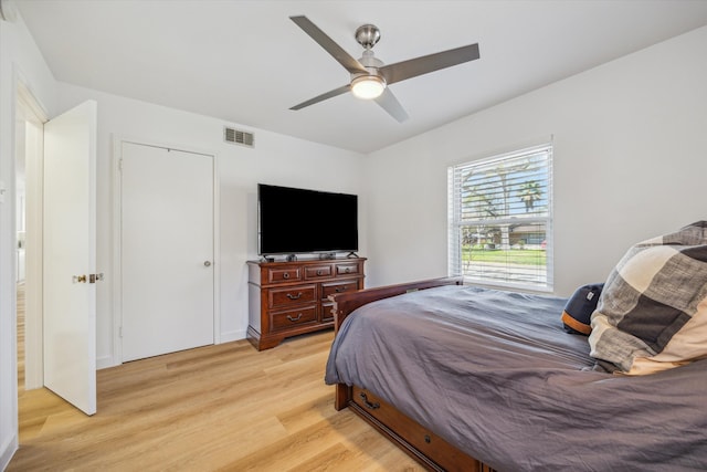 bedroom with visible vents, a ceiling fan, and light wood-style floors