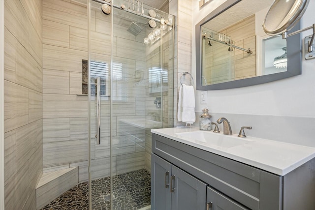 bathroom featuring a shower stall and vanity