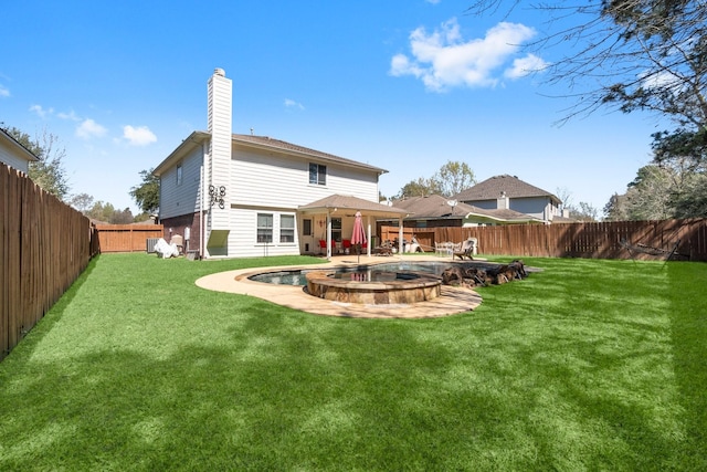 back of house featuring a fenced in pool, a yard, a fenced backyard, a chimney, and a patio area