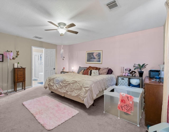 bedroom with visible vents, carpet flooring, ensuite bathroom, and ceiling fan