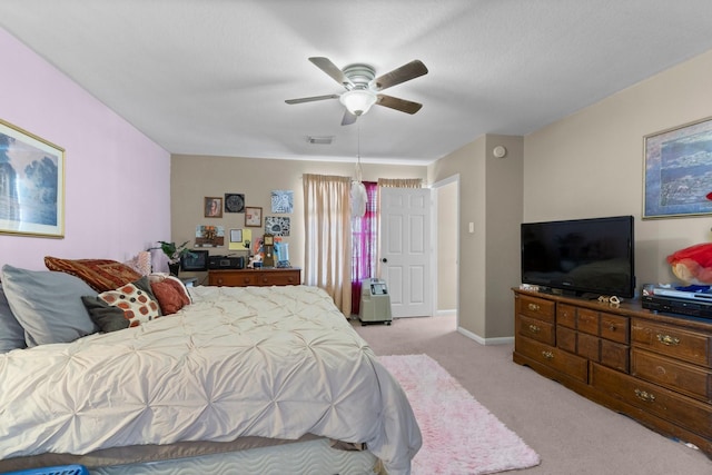 bedroom featuring visible vents, light colored carpet, baseboards, and ceiling fan