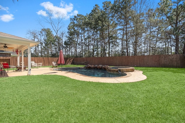 view of yard featuring ceiling fan, a patio, a fenced backyard, and a pool with connected hot tub