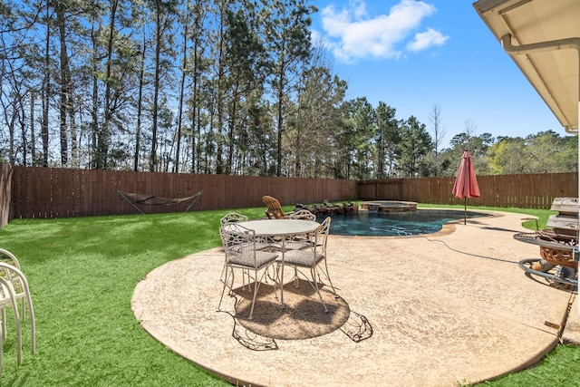 exterior space with a patio area, a pool with connected hot tub, and a fenced backyard