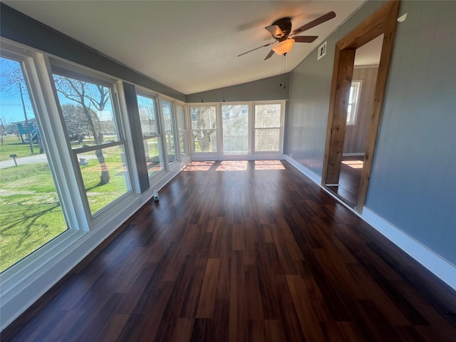 unfurnished sunroom featuring vaulted ceiling, visible vents, a wealth of natural light, and ceiling fan