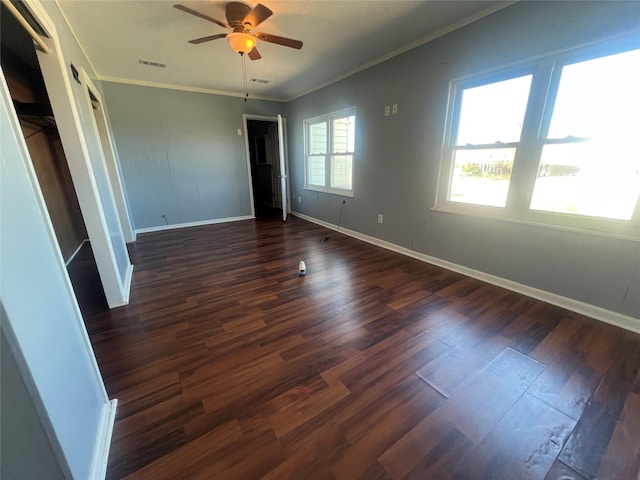 interior space featuring ceiling fan, baseboards, dark wood-type flooring, and ornamental molding