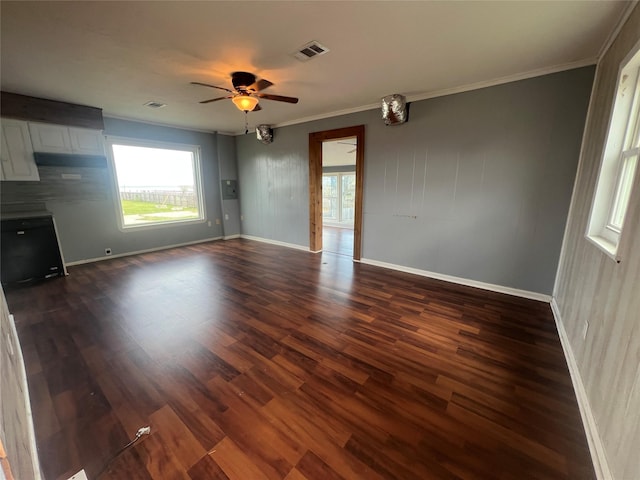 interior space with visible vents, baseboards, dark wood-style floors, and crown molding