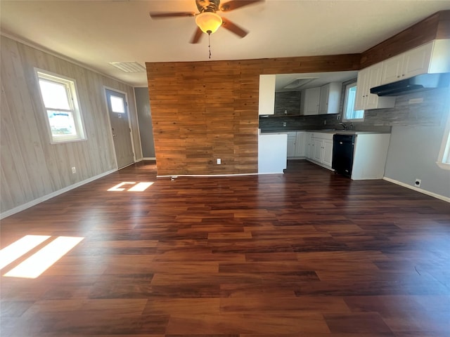 kitchen with dark wood finished floors, open floor plan, a healthy amount of sunlight, and black dishwasher