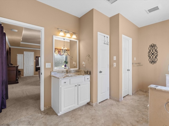 bathroom featuring vanity, baseboards, visible vents, tile patterned floors, and a notable chandelier