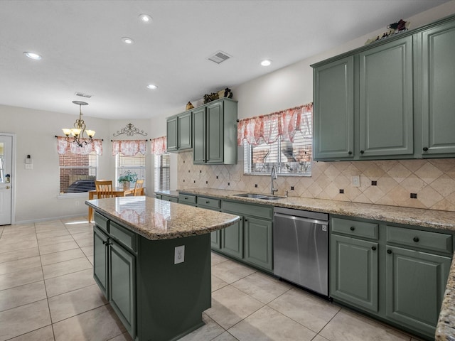 kitchen with green cabinetry, visible vents, dishwasher, and a sink