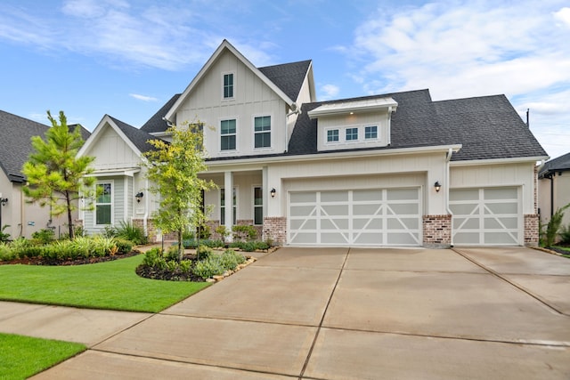 modern farmhouse with driveway, board and batten siding, a front yard, a garage, and brick siding