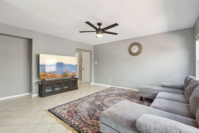 tiled living room featuring baseboards and ceiling fan