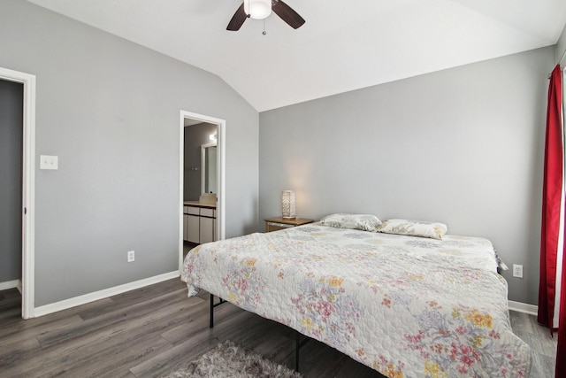 bedroom featuring lofted ceiling, a ceiling fan, ensuite bath, wood finished floors, and baseboards