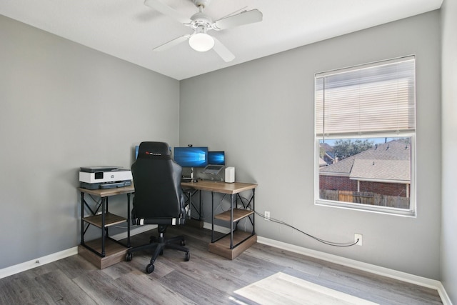 office space featuring wood finished floors, baseboards, and ceiling fan