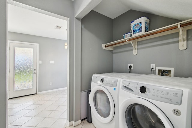 laundry room featuring visible vents, washer and clothes dryer, light tile patterned floors, baseboards, and laundry area