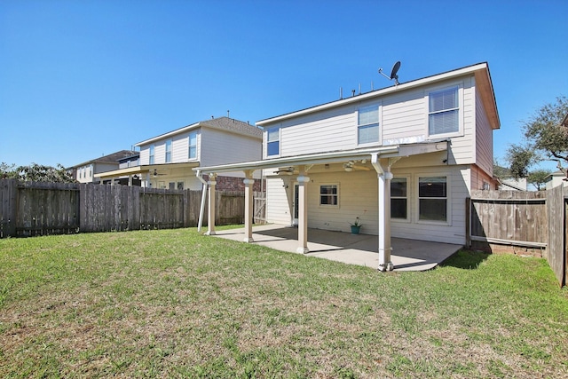 back of property featuring a patio, a lawn, a fenced backyard, and a ceiling fan