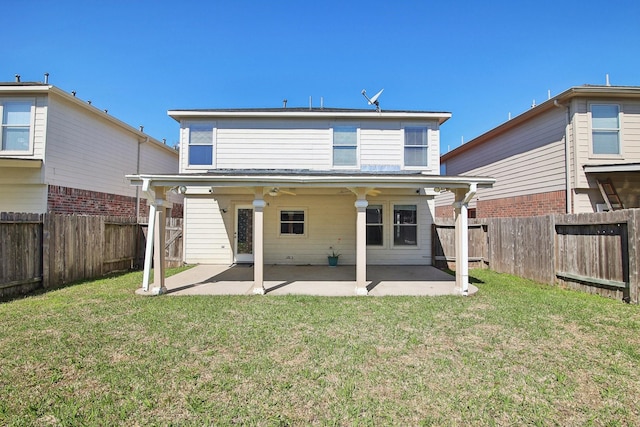 back of property with a patio area, a lawn, a ceiling fan, and a fenced backyard