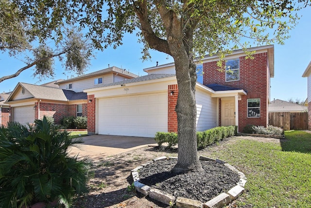 traditional-style home with brick siding, fence, a garage, and driveway