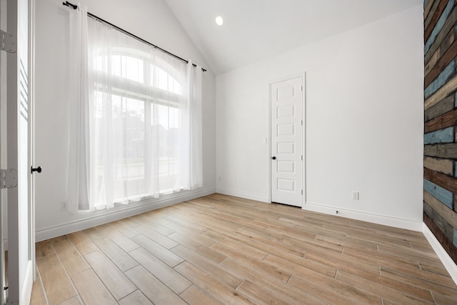 unfurnished room with recessed lighting, baseboards, light wood finished floors, and vaulted ceiling