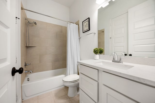 full bath featuring vanity, tile patterned floors, toilet, and shower / bath combo with shower curtain