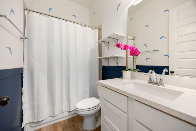 full bath featuring vanity, toilet, and wood finished floors