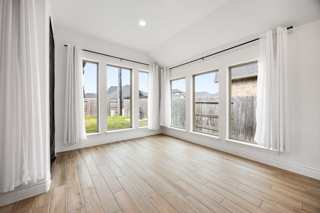 unfurnished sunroom featuring lofted ceiling