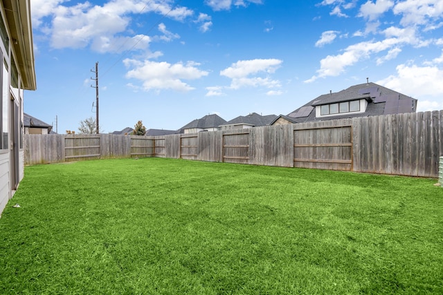 view of yard with a fenced backyard