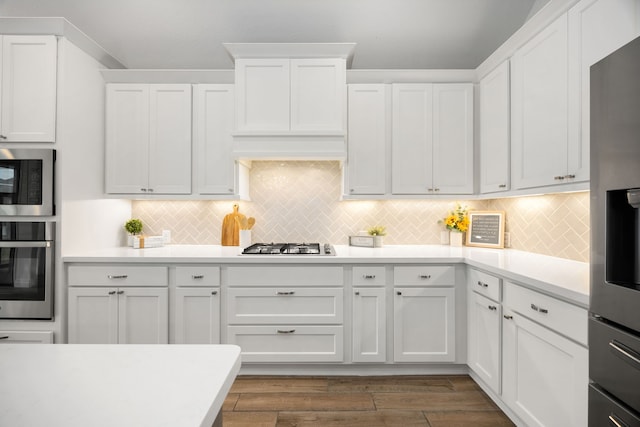 kitchen with light countertops, white cabinets, tasteful backsplash, and appliances with stainless steel finishes