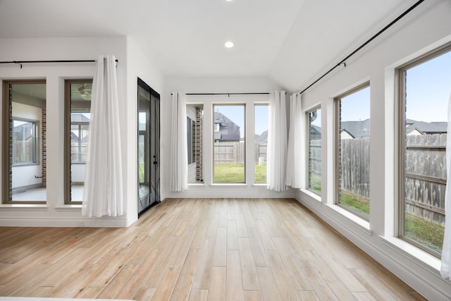 unfurnished sunroom featuring lofted ceiling