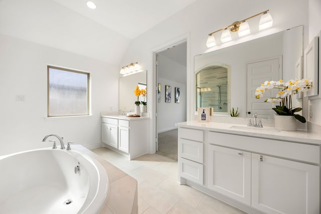 bathroom featuring tile patterned floors, two vanities, a stall shower, a sink, and a bath