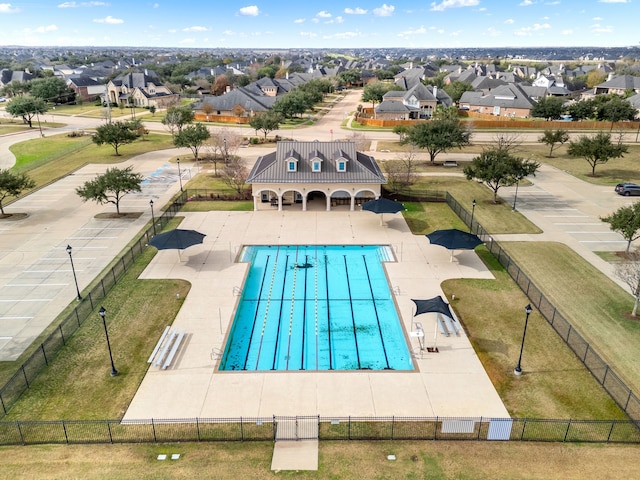 view of pool with a patio area, a residential view, and fence