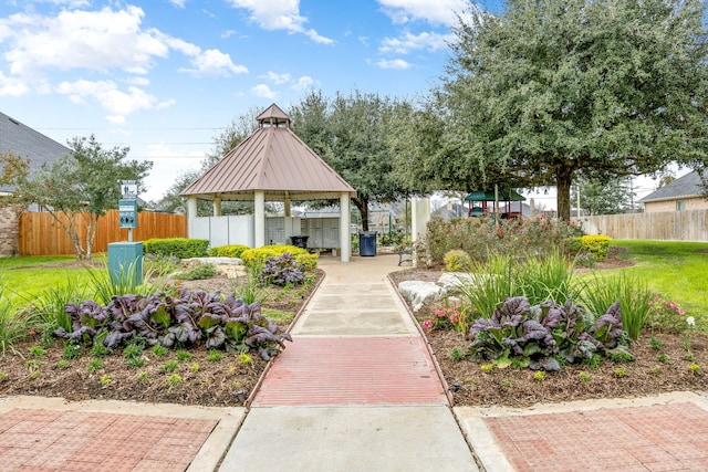 view of home's community with a gazebo and fence