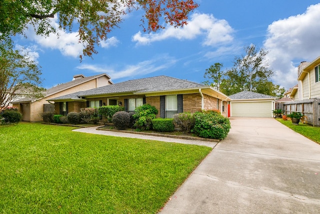 ranch-style house featuring a front lawn, an outbuilding, and brick siding