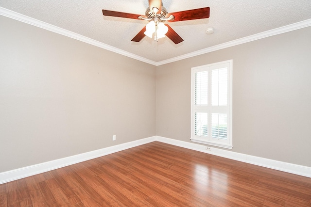 spare room with a ceiling fan, a textured ceiling, wood finished floors, crown molding, and baseboards