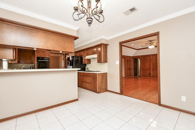 kitchen with visible vents, black oven, under cabinet range hood, ornamental molding, and brown cabinetry