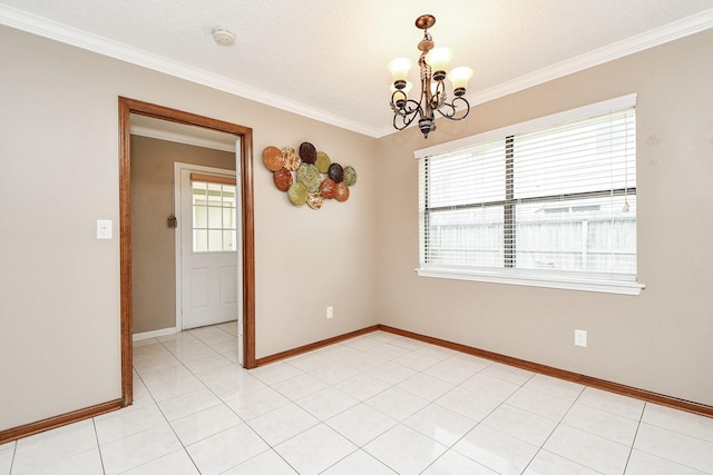 spare room with light tile patterned floors, baseboards, a notable chandelier, and ornamental molding