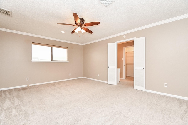 spare room with light carpet, visible vents, and ornamental molding