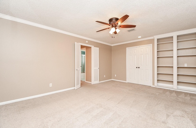 unfurnished bedroom with ornamental molding, a textured ceiling, baseboards, light colored carpet, and ceiling fan