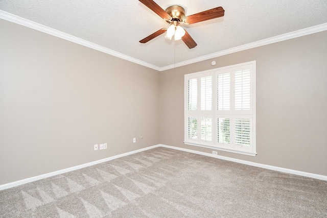 carpeted empty room with a textured ceiling, a ceiling fan, baseboards, and ornamental molding